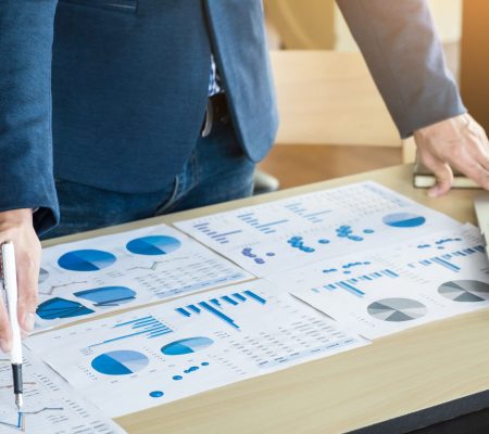 team-work-process-young-business-managers-crew-working-with-new-startup-project-labtop-wood-table-typing-keyboard-texting-message-analyze-graph-plans (1)